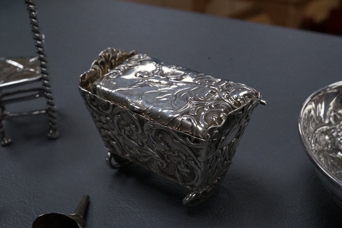 A small group of collectable silver including a Dutch miniature silver cradle box, import marks for London, 1898, 53mm, two other white metal miniature items including a chair, a continental 930 white metal taste vin, a